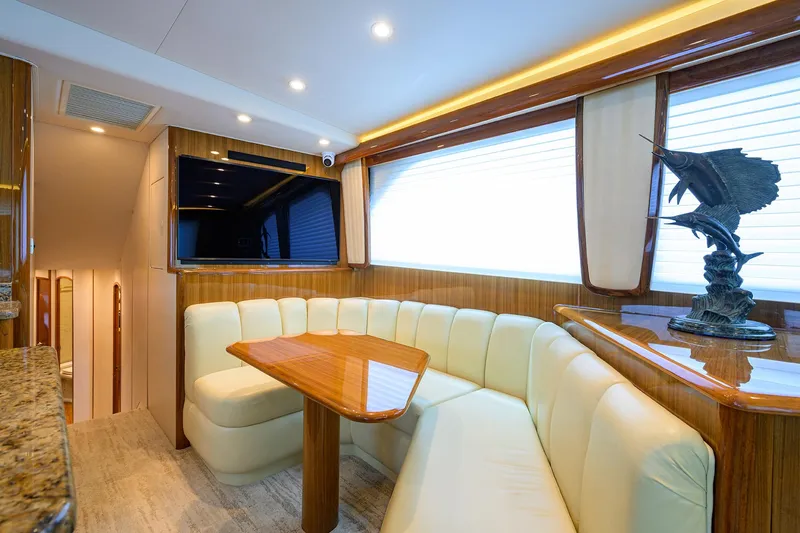  Yacht Photos Pics Luxurious interior of 2008 Viking 56 Enclosed Bridge yacht with plush seating and elegant decor.