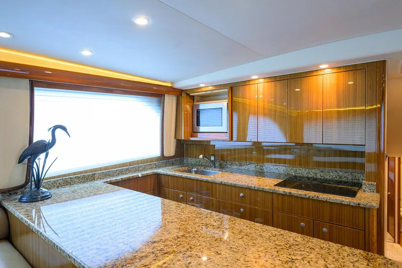  Yacht Photos Pics Luxurious kitchen interior of 2008 Viking 56 Enclosed Bridge yacht with granite countertops.