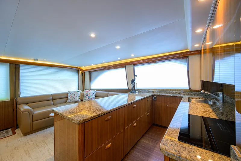  Yacht Photos Pics Luxurious interior of 2008 Viking 56 Enclosed Bridge yacht with modern kitchen and seating area.