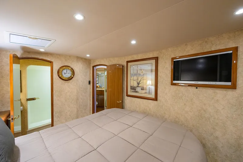  Yacht Photos Pics Luxurious bedroom in 2008 Viking 56 Enclosed Bridge yacht with TV and elegant decor.