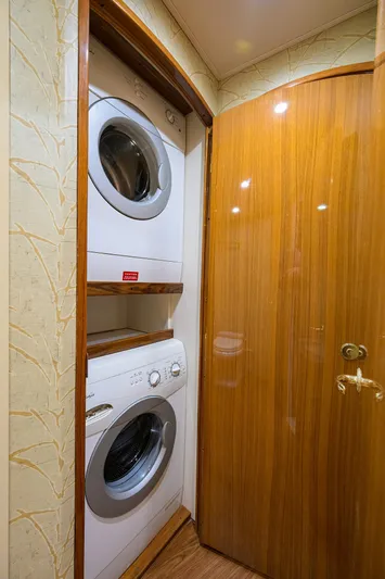 Yacht Photos Pics Laundry area inside 2008 Viking 56 Enclosed Bridge yacht with stacked washer and dryer.