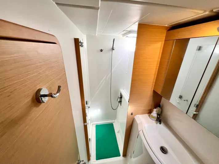 Celestra Yacht Photos Pics 2017 Lagoon 400 S2 yacht bathroom with shower, sink, and wooden accents.