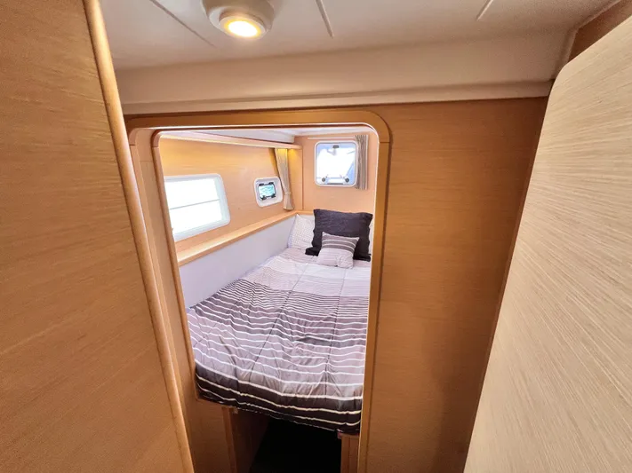 Celestra Yacht Photos Pics 2017 Lagoon 400 S2 yacht cabin with cozy bed and striped bedding.
