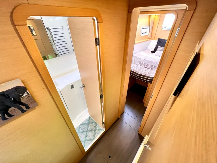 Celestra Yacht Photos Pics Interior of 2017 Lagoon 400 S2 yacht showing hallway, bathroom, and bedroom.