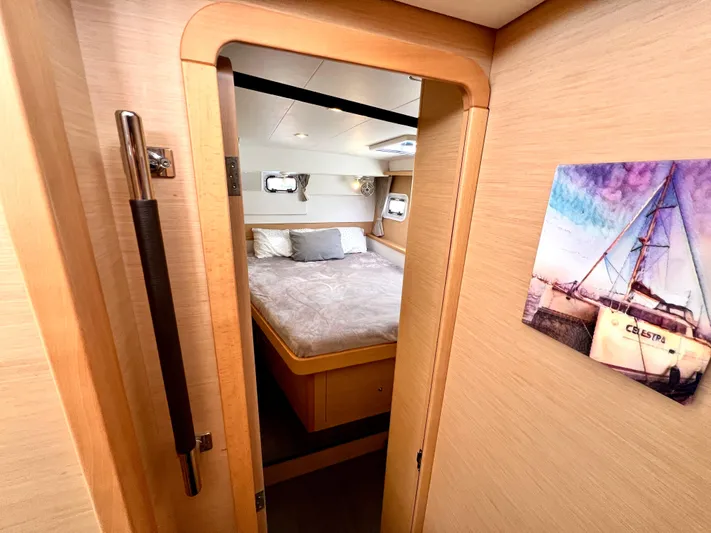 Celestra Yacht Photos Pics Cozy bedroom interior of 2017 Lagoon 400 S2 yacht with wooden finish and nautical decor.
