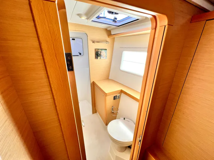 Celestra Yacht Photos Pics 2017 Lagoon 400 S2 yacht bathroom with wooden interior and skylight.