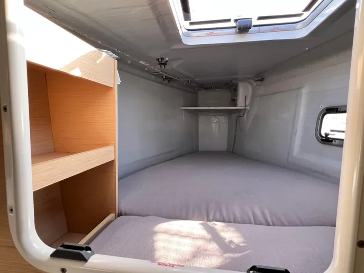 Celestra Yacht Photos Pics Cozy cabin interior of 2017 Lagoon 400 S2 catamaran with bed and shelving.