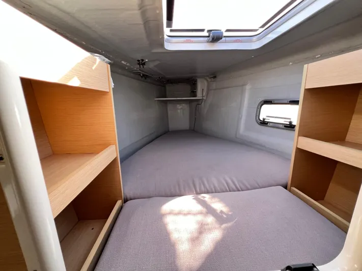 Celestra Yacht Photos Pics Cozy cabin interior of 2017 Lagoon 400 S2 catamaran with shelves and bedding.