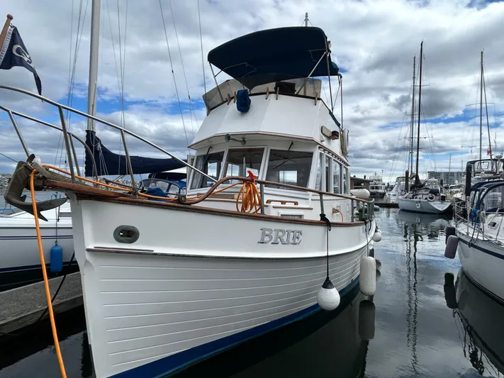 Brie Yacht Photos Pics 1980 Grand Banks 36 Classic boat docked in a marina under cloudy skies.