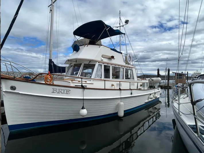 Brie Yacht Photos Pics 1980 Grand Banks 36 Classic yacht docked at marina under cloudy sky.