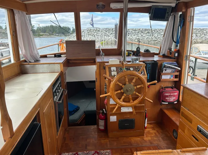 Brie Yacht Photos Pics Interior of a 1980 Grand Banks 36 Classic boat with wooden helm and navigation equipment.