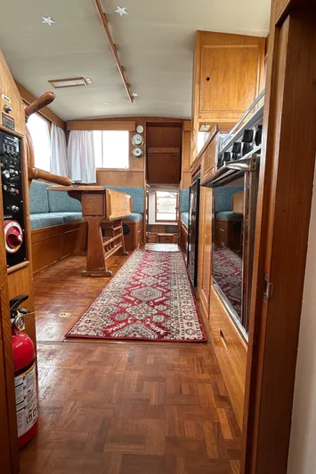 Brie Yacht Photos Pics Interior of 1980 Grand Banks 36 Classic yacht with wood finish and red patterned rug.