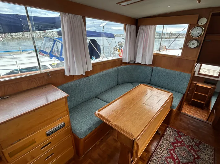 Brie Yacht Photos Pics Interior of 1980 Grand Banks 36 Classic yacht with wooden furnishings and blue seating.