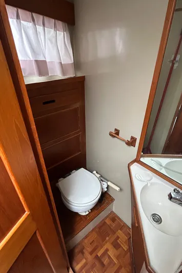 Brie Yacht Photos Pics 1980 Grand Banks 36 Classic bathroom with wooden cabinetry and compact design.