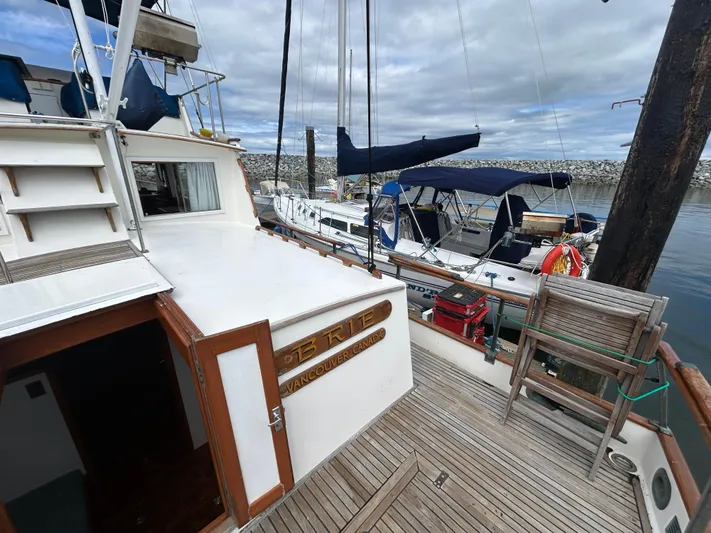 Brie Yacht Photos Pics Grand Banks 36 Classic yacht docked at marina, showcasing wooden deck and nautical equipment.