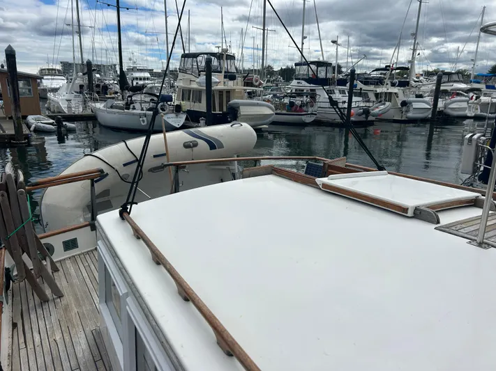 Brie Yacht Photos Pics 1980 Grand Banks 36 Classic yacht docked in a marina with inflatable dinghy.