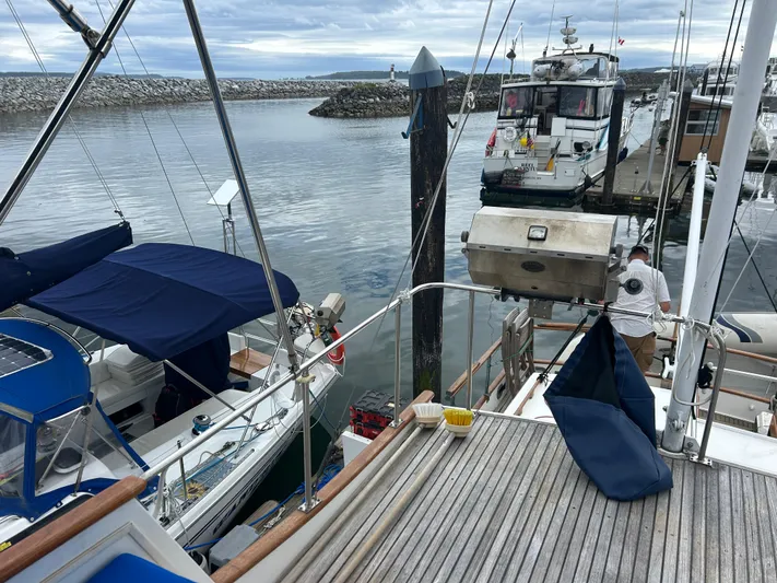 Brie Yacht Photos Pics Grand Banks 36 Classic yacht docked at marina, 1980 model, with nearby boats and calm water.