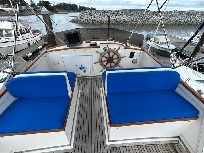 Brie Yacht Photos Pics Cockpit of 1980 Grand Banks 36 Classic with blue seating and wooden steering wheel.