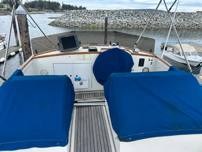 Brie Yacht Photos Pics Flybridge of 1980 Grand Banks 36 Classic yacht with blue covers and navigation equipment.