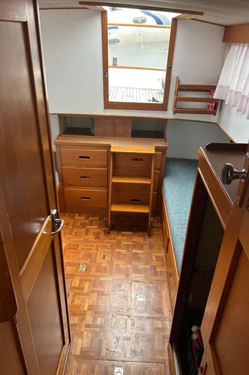 Brie Yacht Photos Pics Interior of 1980 Grand Banks 36 Classic boat with wooden cabinetry and parquet flooring.