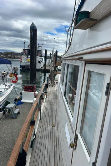 Brie Yacht Photos Pics 1980 Grand Banks 36 Classic yacht docked at marina under cloudy sky.
