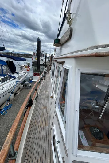 Brie Yacht Photos Pics 1980 Grand Banks 36 Classic yacht docked at marina under cloudy sky.