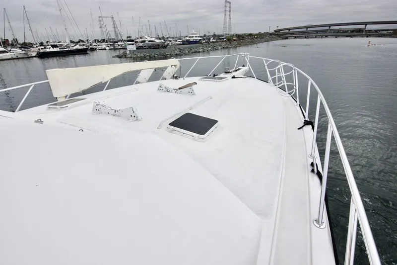 Tres Juanes Yacht Photos Pics 1997 Bertram 54 Convertible yacht docked in a marina, showcasing its spacious deck.