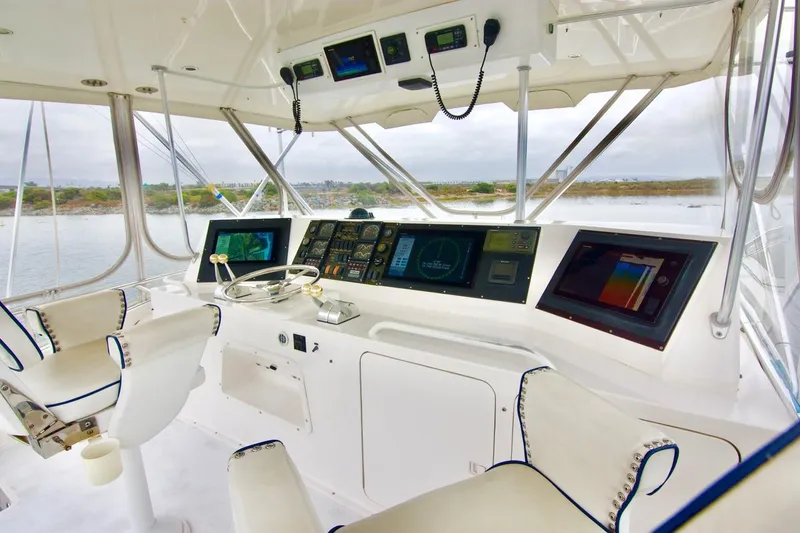 Tres Juanes Yacht Photos Pics 1997 Bertram 54 Convertible yacht helm with advanced navigation systems and dual captain chairs.