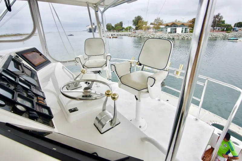 Tres Juanes Yacht Photos Pics 1997 Bertram 54 Convertible yacht helm with dual captain chairs and navigational controls.