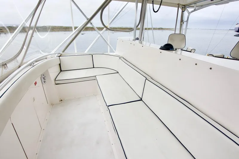 Tres Juanes Yacht Photos Pics 1997 Bertram 54 Convertible yacht interior with white seating and ocean view.