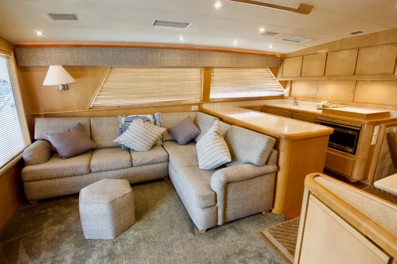 Tres Juanes Yacht Photos Pics Luxurious interior of a 1997 Bertram 54 Convertible yacht with cozy seating and modern kitchen.