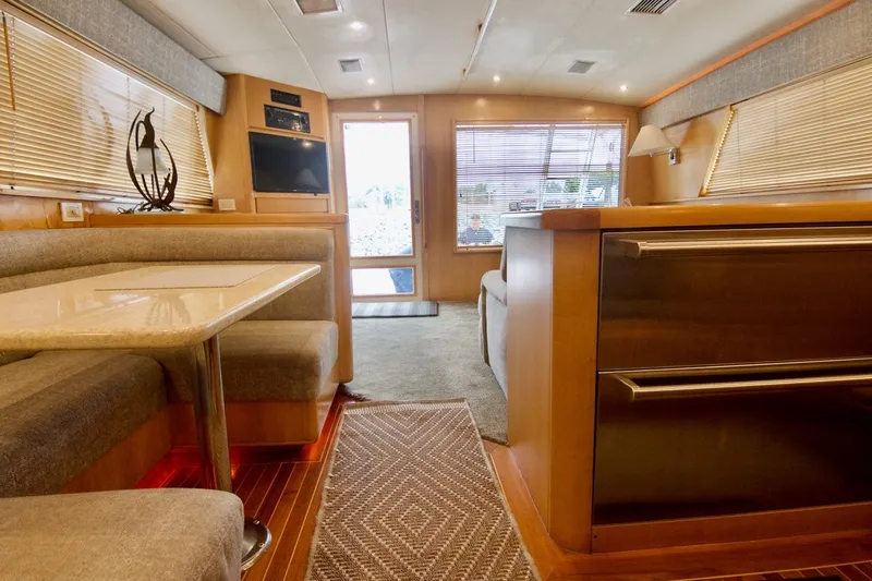 Tres Juanes Yacht Photos Pics Interior of a 1997 Bertram 54 Convertible yacht with cozy seating and modern decor.