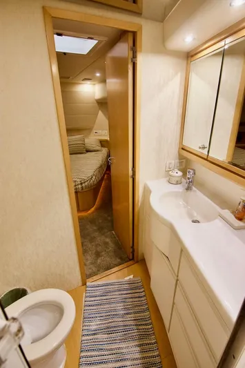 Tres Juanes Yacht Photos Pics 1997 Bertram 54 Convertible yacht interior with bathroom and bedroom view.