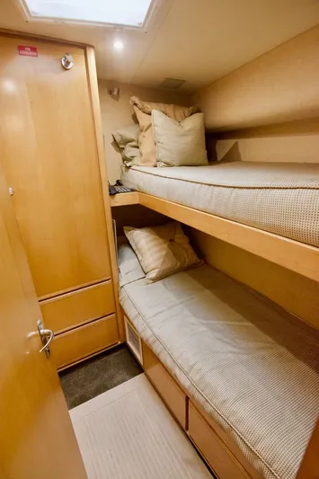 Tres Juanes Yacht Photos Pics 1997 Bertram 54 Convertible cabin with cozy bunk beds and wooden interior.