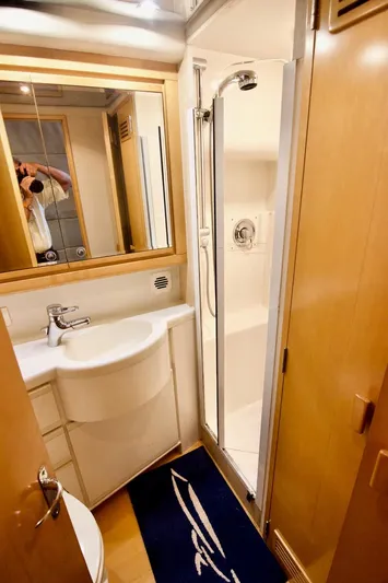 Tres Juanes Yacht Photos Pics Bathroom interior of 1997 Bertram 54 Convertible yacht, featuring shower and sink.