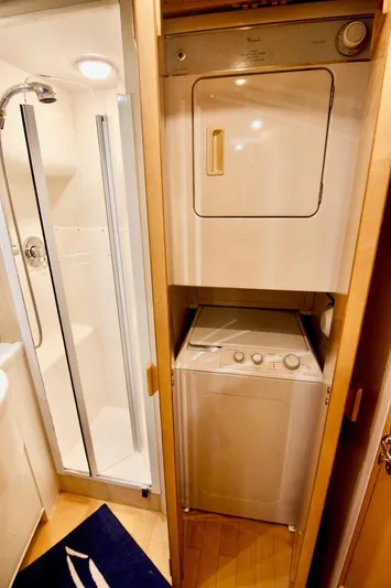 Tres Juanes Yacht Photos Pics Laundry area and shower in 1997 Bertram 54 Convertible yacht interior.