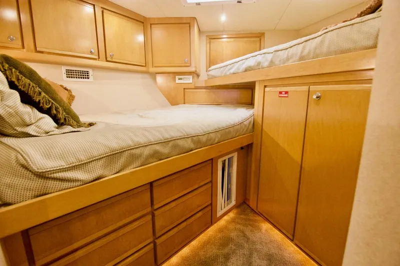 Tres Juanes Yacht Photos Pics 1997 Bertram 54 Convertible cabin with wooden cabinetry and twin beds.
