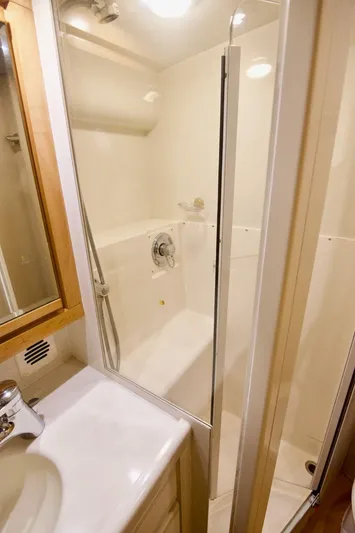 Tres Juanes Yacht Photos Pics Bathroom interior of 1997 Bertram 54 Convertible yacht with shower and sink.