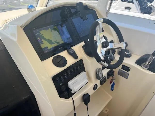  Yacht Photos Pics 2019 Regal 33 SAV boat dashboard with steering wheel and navigation screens.