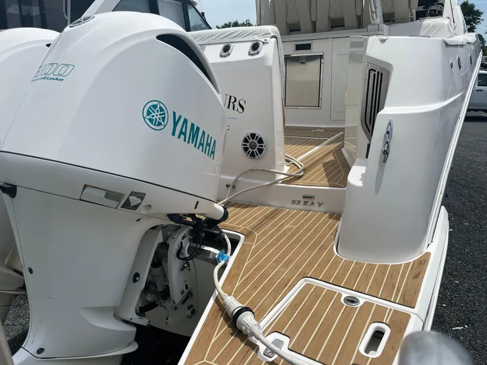  Yacht Photos Pics 2019 Regal 33 SAV boat with Yamaha outboard engine, teak deck, and spacious seating area.
