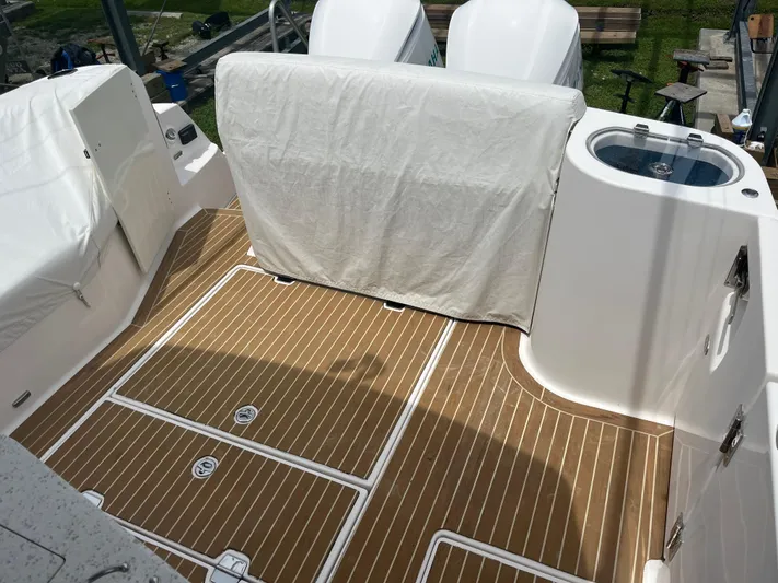  Yacht Photos Pics 2019 Regal 33 SAV boat deck with wood finish and covered seating area.