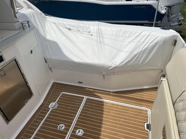  Yacht Photos Pics 2019 Regal 33 SAV boat interior with teak flooring and covered seating area.