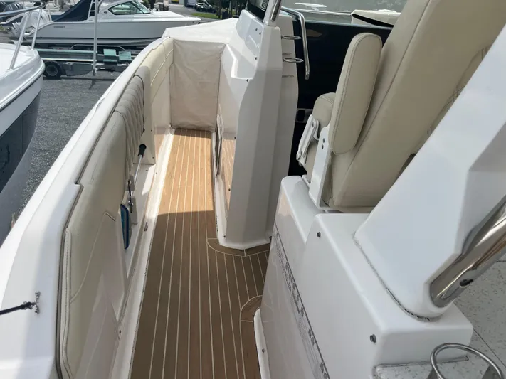  Yacht Photos Pics 2019 Regal 33 SAV boat interior with beige seating and wood-style flooring.