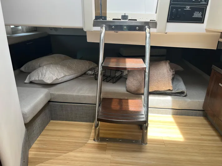  Yacht Photos Pics Interior cabin of 2019 Regal 33 SAV boat with wooden steps and bedding.