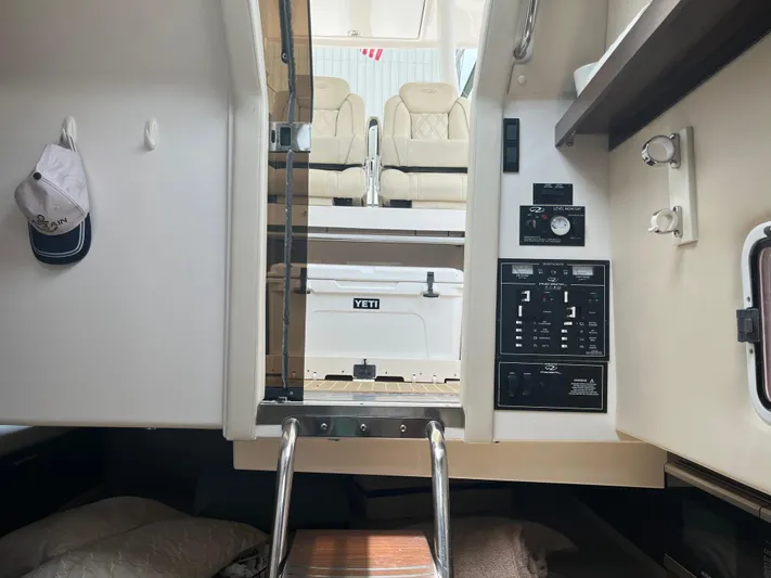  Yacht Photos Pics Interior view of 2019 Regal 33 SAV boat cabin with control panel and seating area.