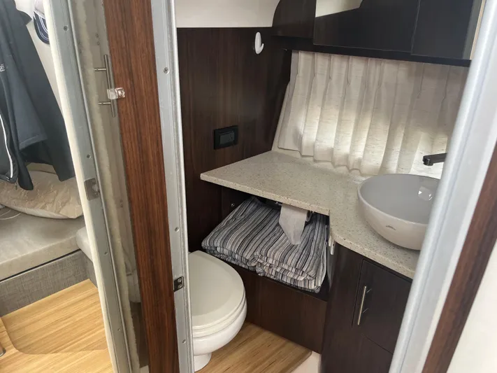  Yacht Photos Pics 2019 Regal 33 SAV boat interior bathroom with modern sink and wooden cabinetry.