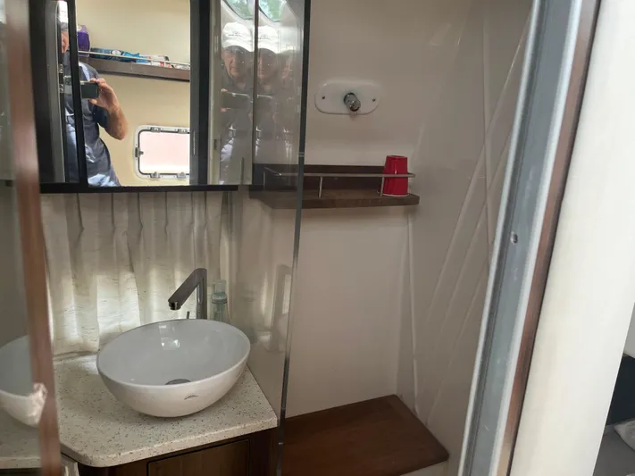  Yacht Photos Pics Bathroom interior of 2019 Regal 33 SAV boat with sink and mirror.