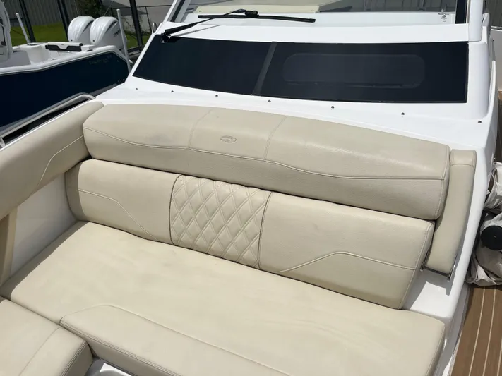  Yacht Photos Pics Luxurious seating on a 2019 Regal 33 SAV boat, featuring elegant beige upholstery.