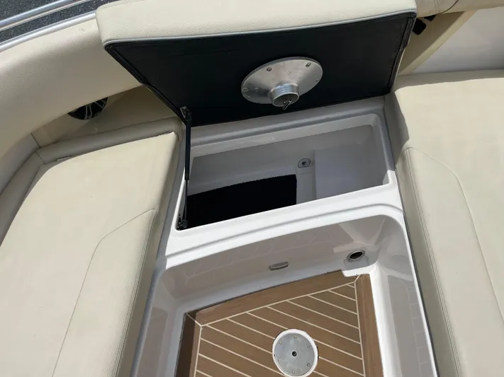  Yacht Photos Pics Open storage compartment on a 2019 Regal 33 SAV boat with cushioned seating.