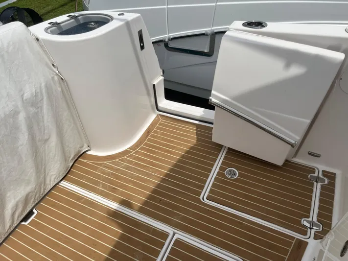  Yacht Photos Pics 2019 Regal 33 SAV boat deck with wood flooring and storage compartments.